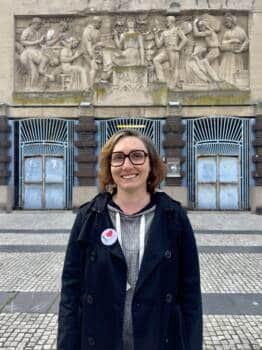 Portrait de la guide conférencière Emilie Ternon devant la Bourse du Travail qui parle de l'Art Déco à Calais